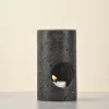 Black Travertine Candle Holder front view with candle lit