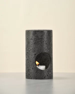 Black Travertine Candle Holder front view with candle lit