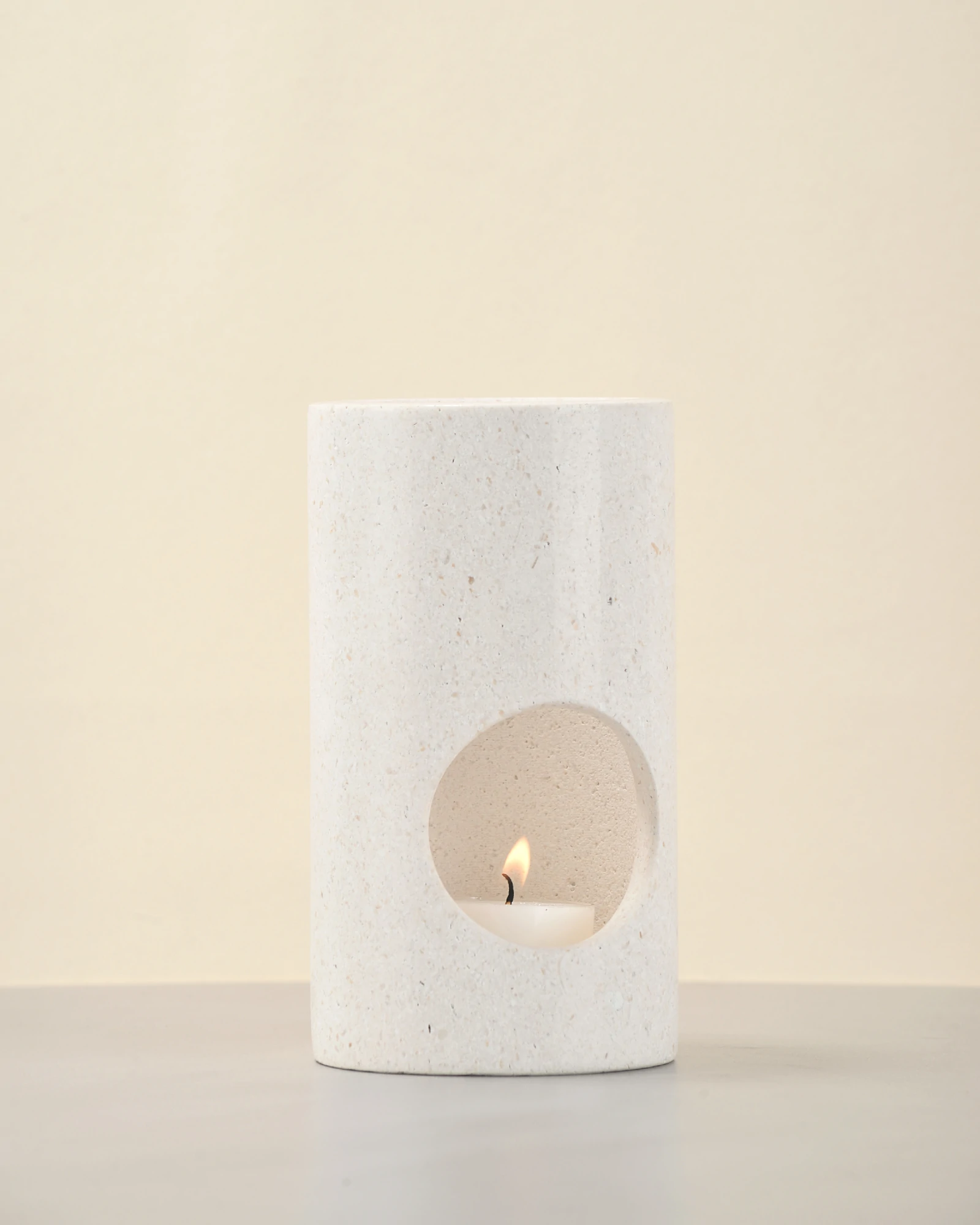 White Stone Candle Holder front view with candle lit