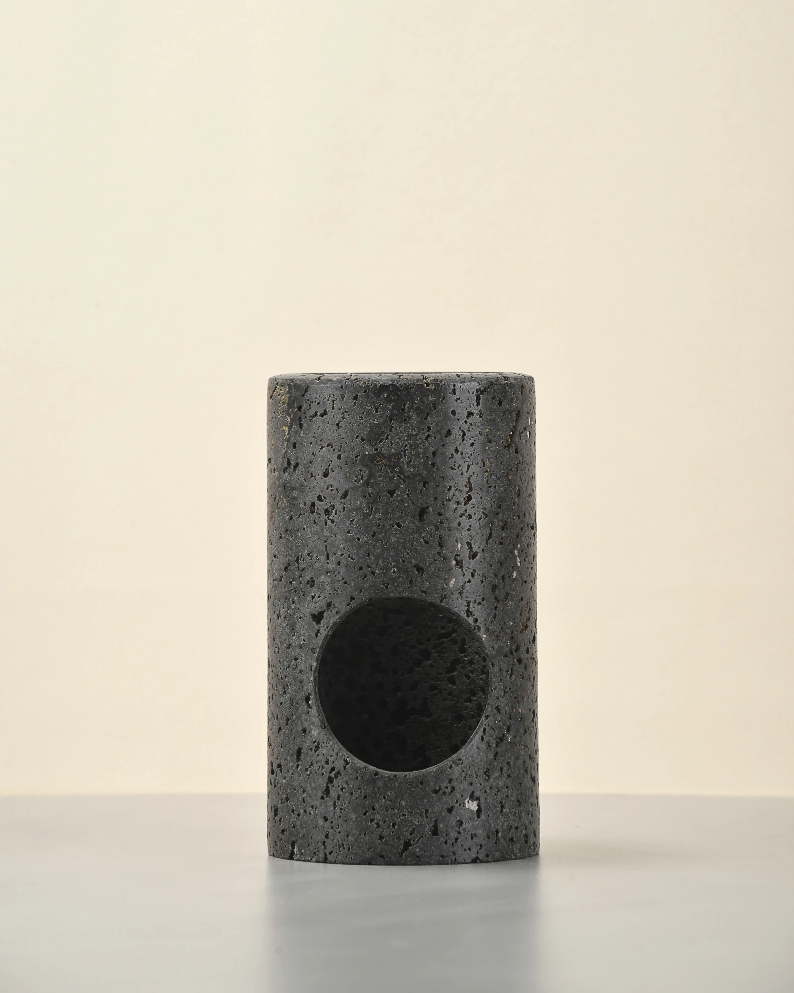 Black Travertine Candle Holder front view, minimalist cylinder shape