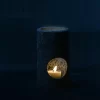 Black Travertine Candle Holder glowing at night with warm candlelight