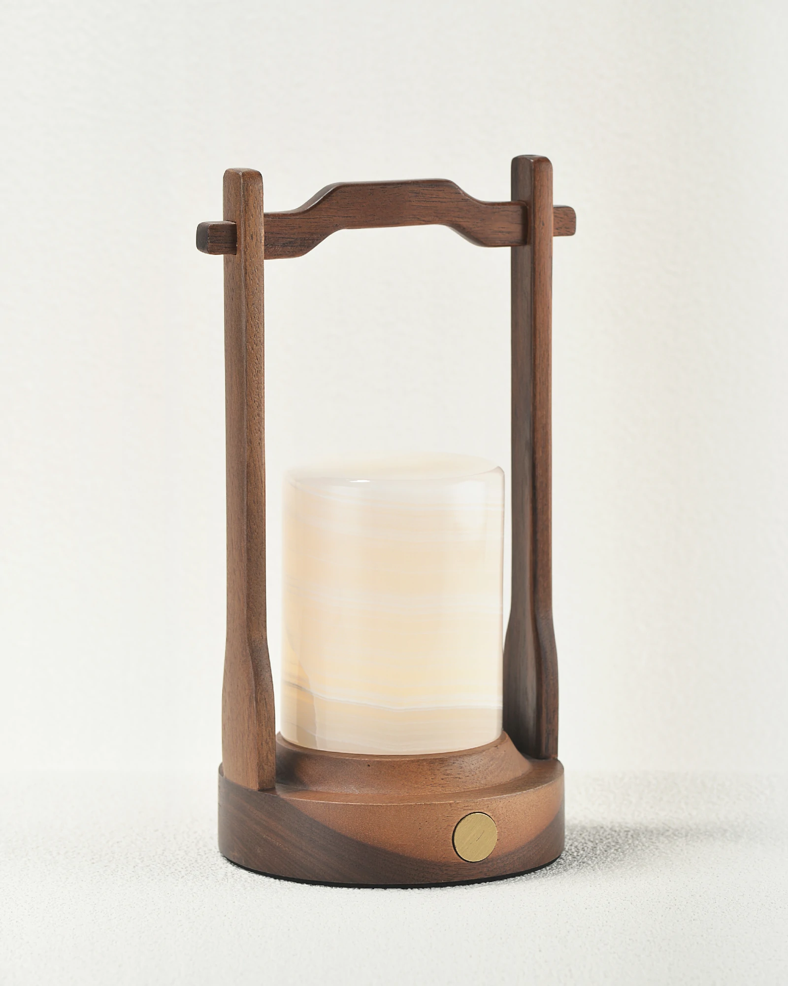 Portable white onyx table lamp with walnut wood handle and base