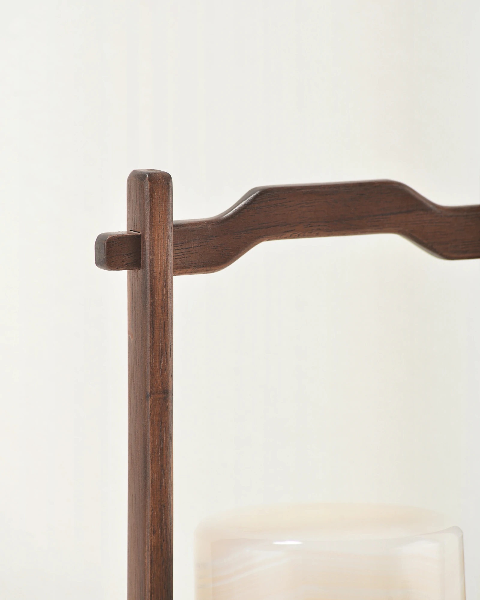 Close-up of walnut handle on portable white onyx lamp