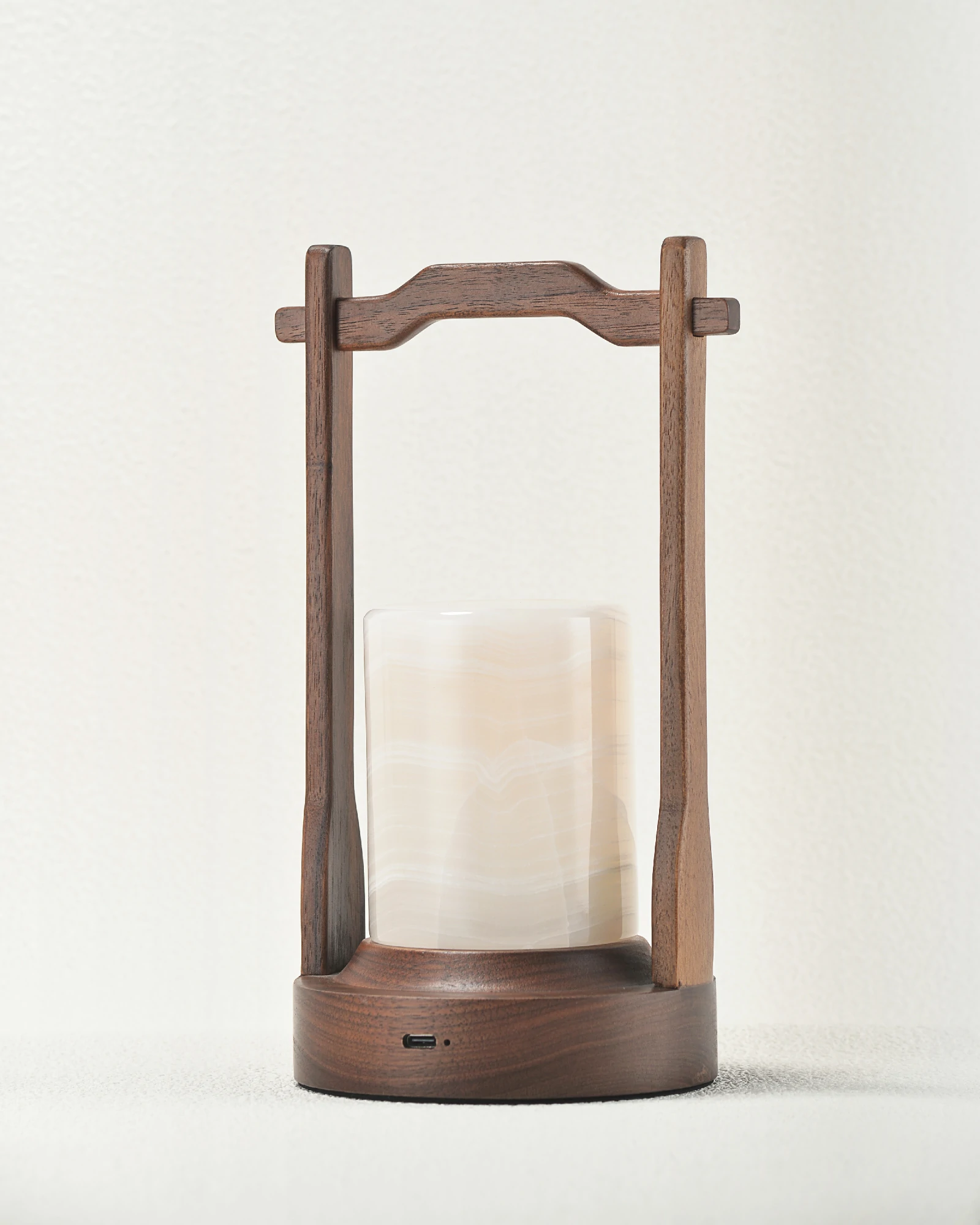 Rear angle of portable white onyx lamp with walnut handle