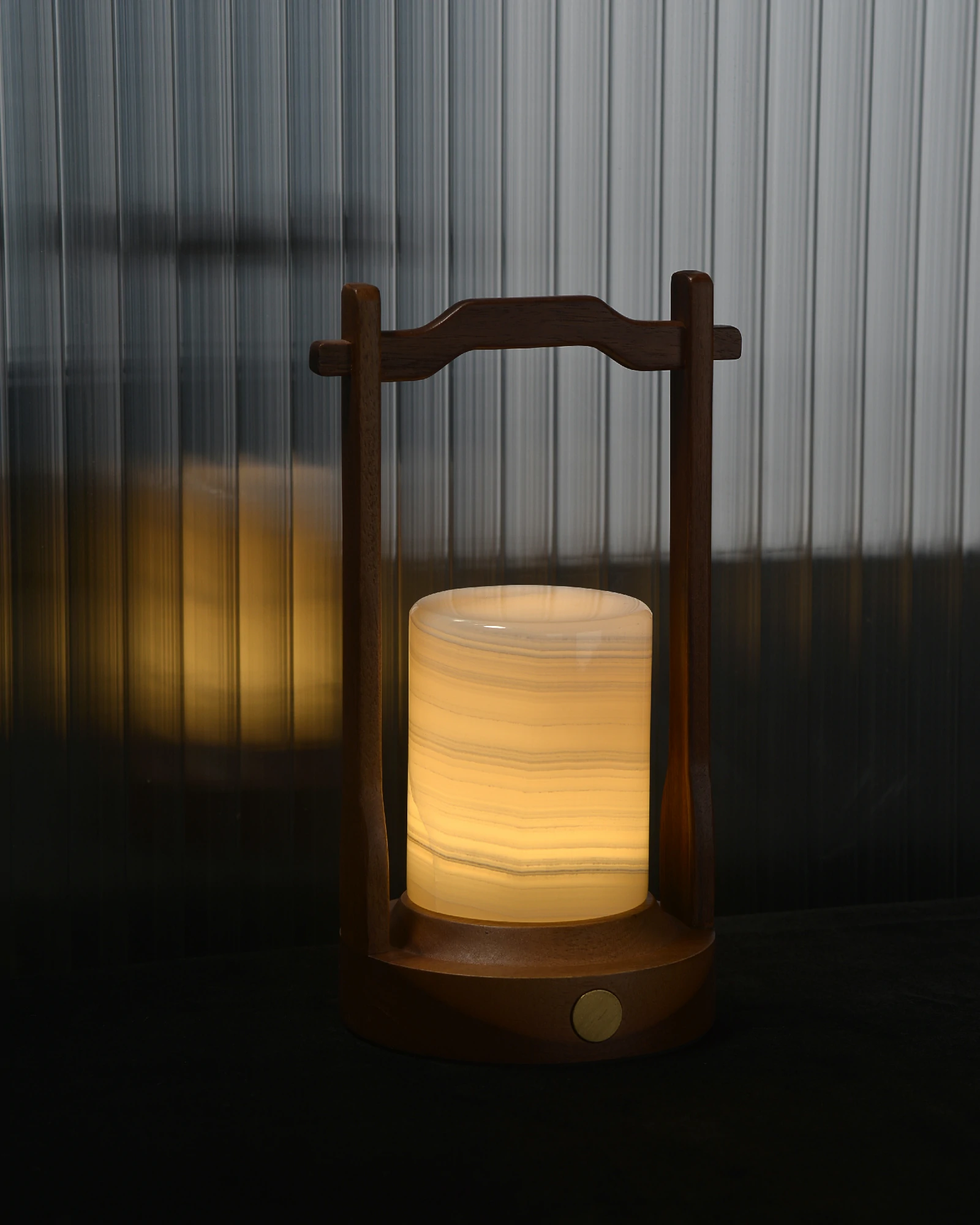 Portable white onyx lamp glowing in dark room with soft light