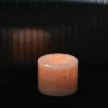 Mini pink onyx table lamp glowing softly in dark setting