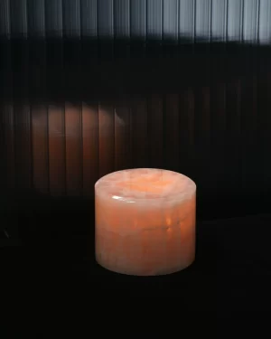 Mini pink onyx table lamp glowing softly in dark setting