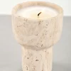 Travertine scented candle holder with candle lit at 45-degree close-up