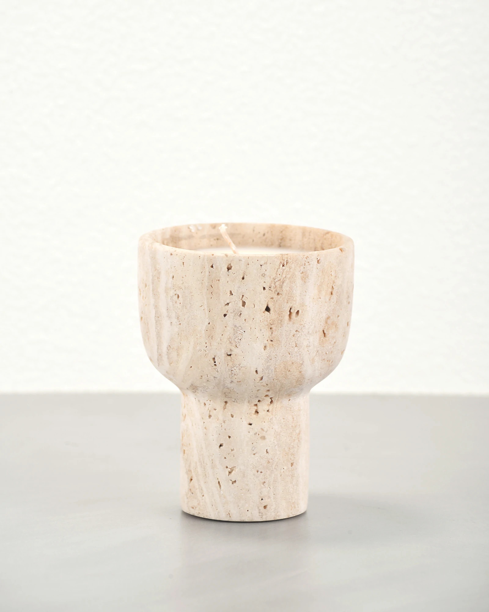 Travertine candle holder showing natural pores at 45-degree angle