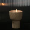 Travertine scented candle holder glowing at night