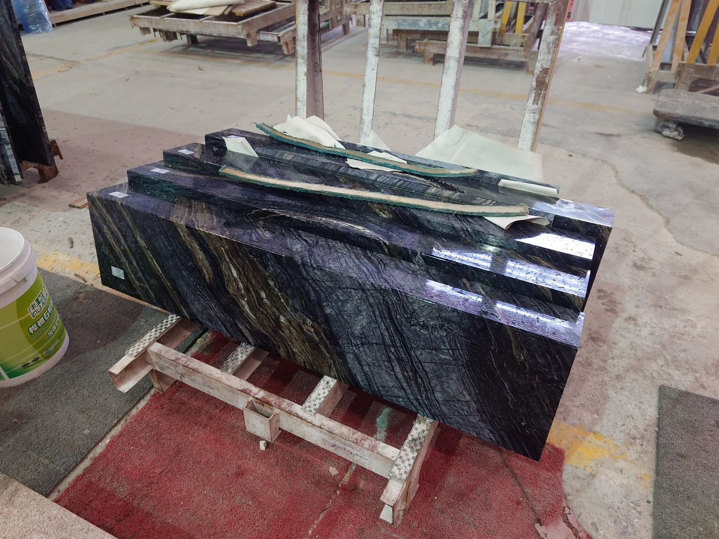 Curved Black Wooden Marble reception desk components after water grinding and before shipment
