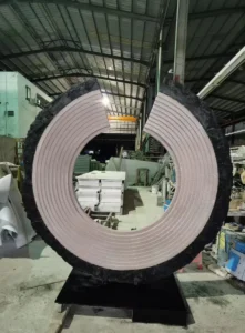 C-shaped Black & White Root Marble sculpture during factory trial assembly