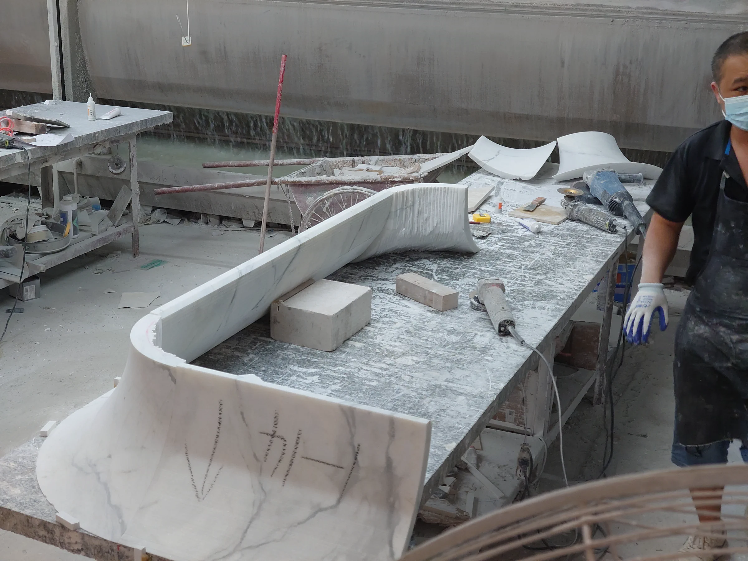Curved Fish Belly White marble components arranged for a second trial assembly check.