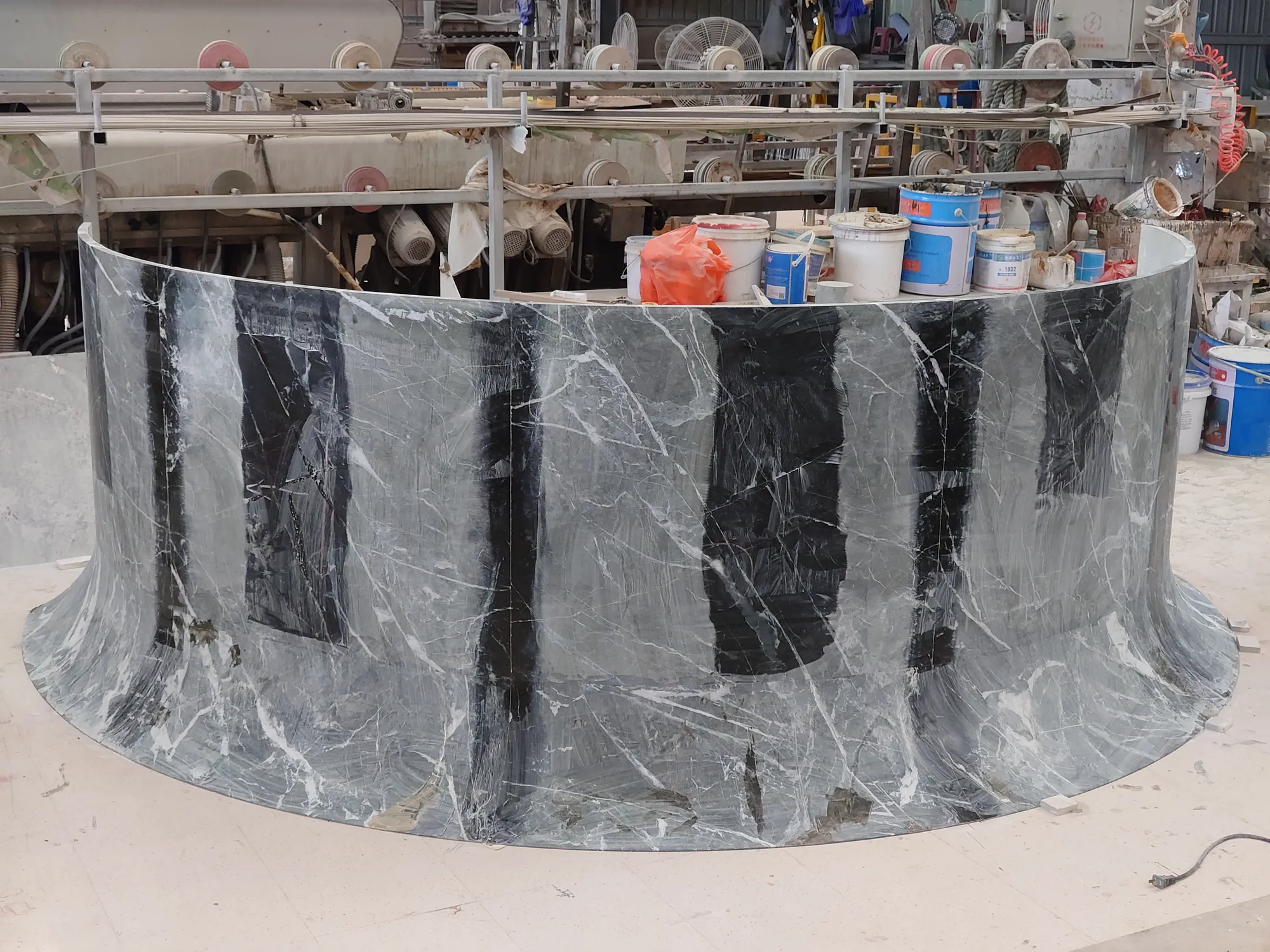 Front view of curved Prada Green marble counter components during trial assembly.