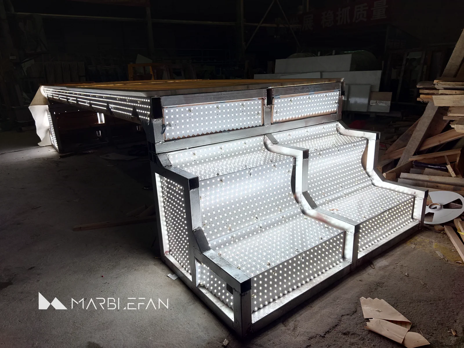 Flexible LED sheets installed across the custom steel table frame.