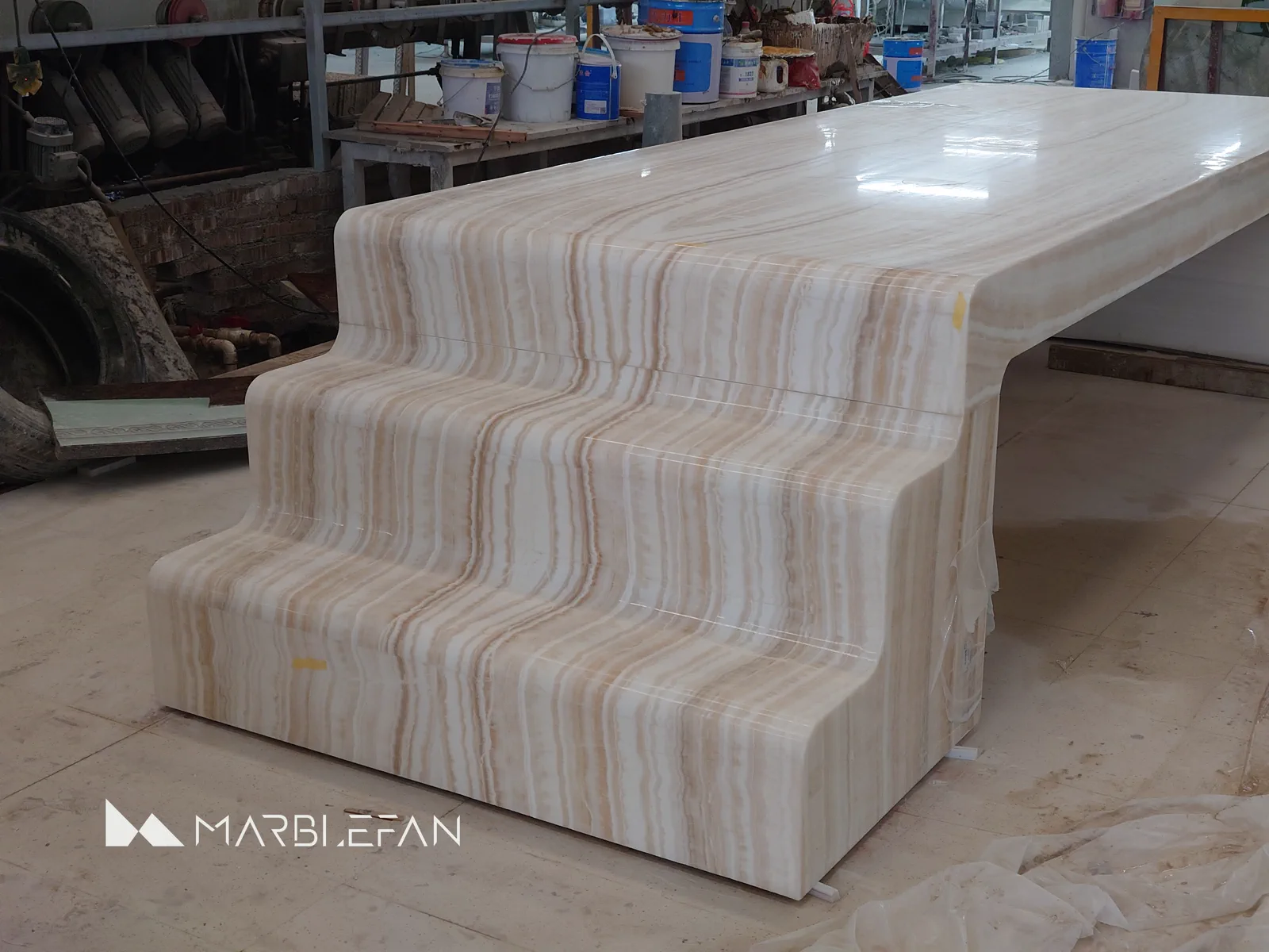 Marble vein continuity around a finished stepped table end.