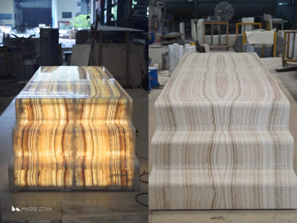 A completed custom backlit marble dining table showing the finished stonework and integrated lighting.