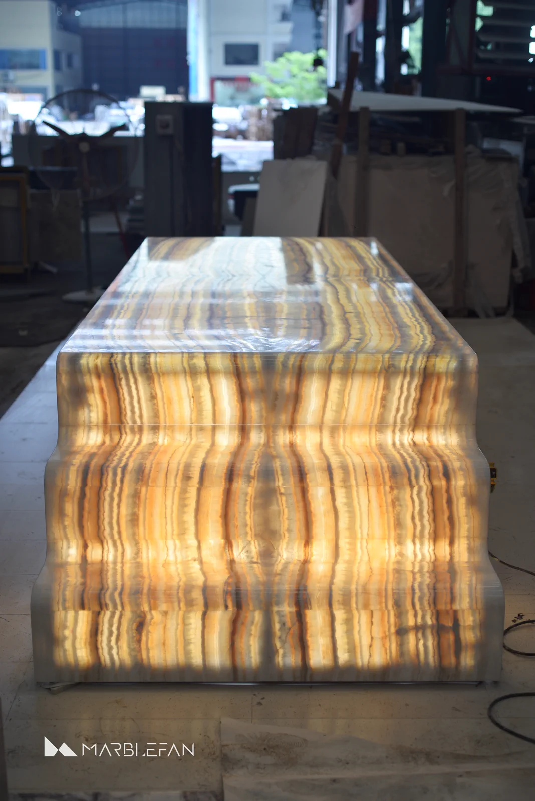 Completed backlit marble dining table illuminated during final workshop testing.