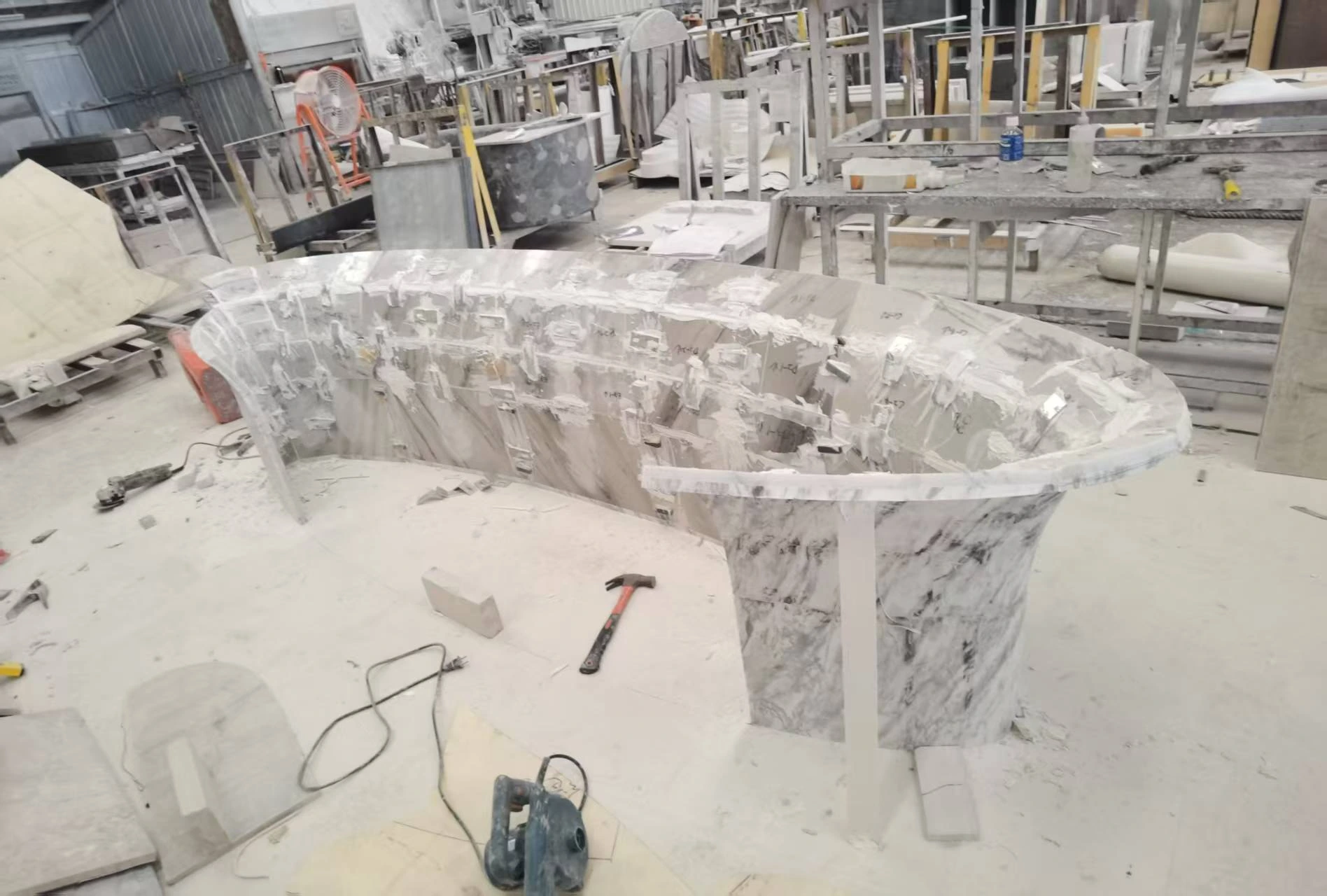 Inside view of curved marble reception desk during factory preassembly