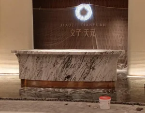 Completed curved marble reception desk installed in a commercial reception area