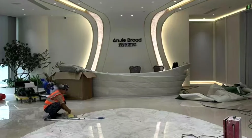 Completed 4.8-meter curved Sivec marble reception desk in a commercial lobby