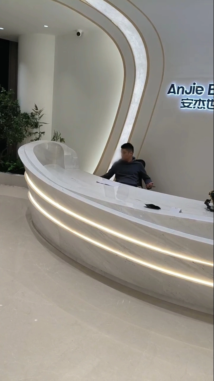 Completed Sivec marble reception desk with concealed LED bands illuminated